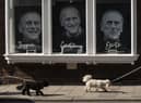 Three portraits are seen in a gallery window near Windsor Castle on April 14, 2021 in Windsor. The Queen announced the death of her husband, His Royal Highness Prince Philip, Duke of Edinburgh, who passed away peacefully on April 9 at Windsor Castle (Photo by Dan Kitwood/Getty Images).