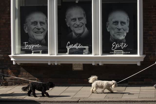 Three portraits are seen in a gallery window near Windsor Castle on April 14, 2021 in Windsor. The Queen announced the death of her husband, His Royal Highness Prince Philip, Duke of Edinburgh, who passed away peacefully on April 9 at Windsor Castle (Photo by Dan Kitwood/Getty Images).