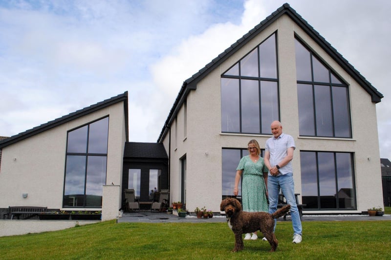 Homeowners Lesley and Erik with their dog, Newton, outside the stunning Skeir A Lidda.