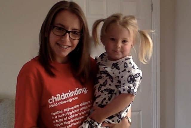 Kelly Eckley from Bonnyrigg in an SCMA t-shirt, with one of her mindees, Evie