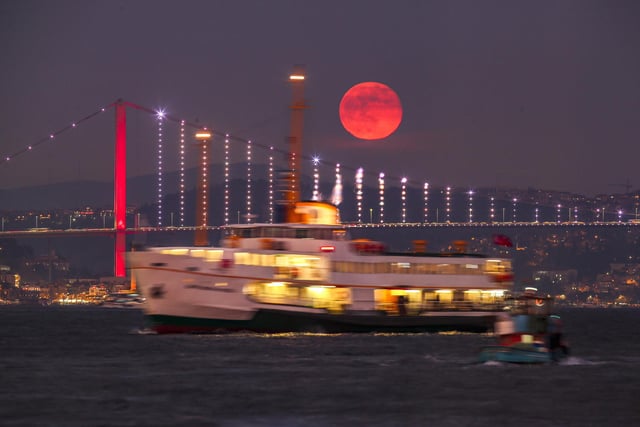 The first full moon of the year rises behind the 15 July Martyrs bridge in Istanbul, Turkey, Saturday, Jan. 7, 2023. (AP Photo/Emrah Gurel)