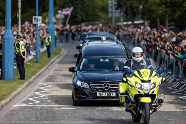The hearse carrying the coffin of Queen Elizabeth II, draped with the Royal Standard of Scotland, passing through Aberdeen (Paul Campbell/PA Wire)