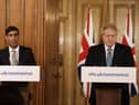Britain's Chancellor Rishi Sunak, left, is flanked by British Prime Minister Boris Johnson as he pledged new support for British businesses. Picture: AP Photo/Matt Dunham