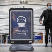 A member of public wears a protective face mask in Waverley Station, Edinburgh, as 121 cases of coronavirus have been reported in the Lothians in the past 24 hours (photo: Jane Barlow).