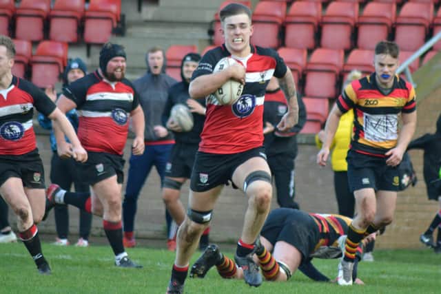 Sam Humphries of Lasswade powers towards the Greenock line for a try (picture by Dean Gibb)