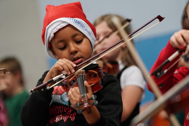 This youngster concentrates on his violin playing during the concert.