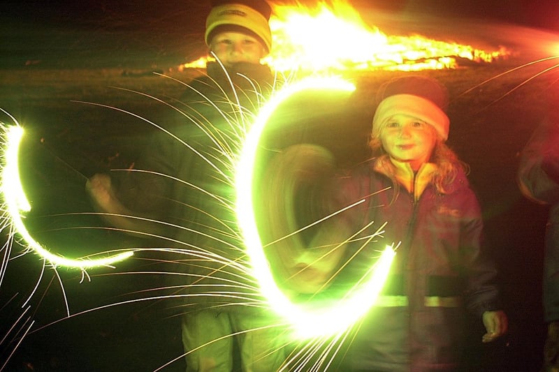 Bonfire Night at George park in Currie, 2001. Kieran Davies, 7, and his sister Lauren, 5, play with sparklers.