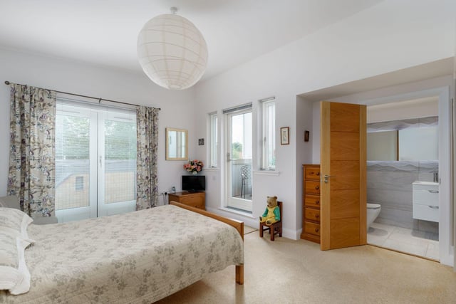 Second floor master bedroom with fitted wardrobes, French doors with Juliet balcony, further door to secluded balcony area and en-suite shower room with walk-in shower, vanity sink & wc.