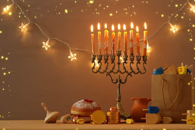 The Menorah holds nine candles, eight of which are lit using the ninth throughout the festival. Photo: tomertu / Getty Images /Canva Pro.