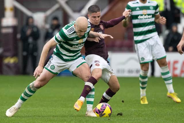 Celtic's Aaron Mooy is beaten to it by Hearts midfielder Cammy Devlin, who was outstanding. Picture: Craig Williamson / SNS