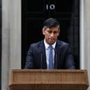 Prime Minister Rishi Sunak, soaked in rain, pauses as he delivers a speech to announce July 4 as the date of the UK's next general election. Picture: AFP via Getty Images