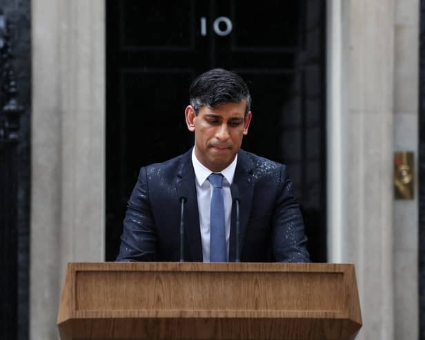 Prime Minister Rishi Sunak, soaked in rain, pauses as he delivers a speech to announce July 4 as the date of the UK's next general election. Picture: AFP via Getty Images