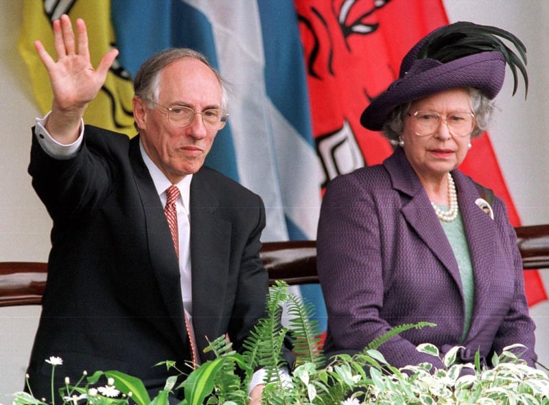 Queen Elizabeth II and Scottish First Minister Donald Dewar watch the parades from the Royal Dias after the opening of the Scottish Parliament in Edinburgh in July 1999.