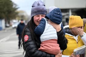 Ukrainian refugees weep after arriving at the Siret border crossing between Romania and Ukraine on Monday (Picture: Daniel Mihailescu/AFP via Getty Images)