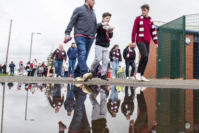 Hearts fans making their way to Hampden following some heavy rain for the Scottish Cup Final. Picture; Lisa Ferguson