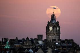 The moon sets behind the Balmoral Clock in Edinburgh. (Picture credit: Jane Barlow/PA Wire)