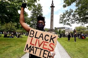 A Black Lives Matter protester at Melville Monument to Henry Dundas in Edinburgh