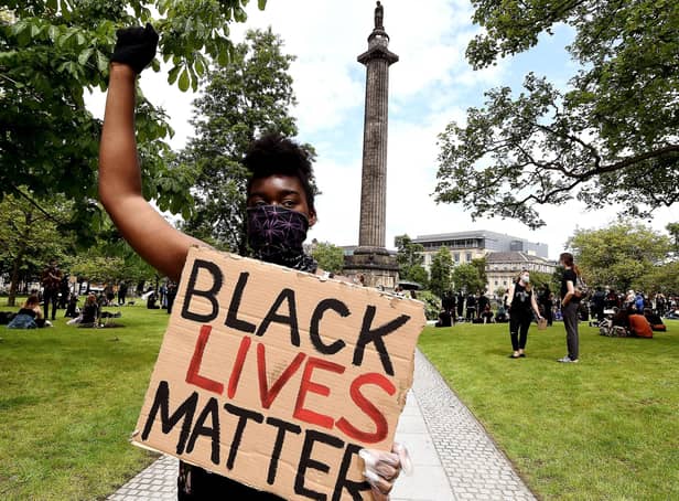 A Black Lives Matter protester at Melville Monument to Henry Dundas in Edinburgh