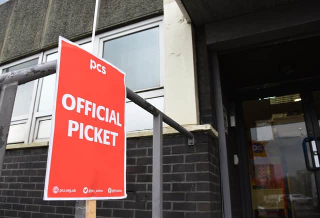 Members of the PCS union formed a picket line outside Wigan Jobcentre