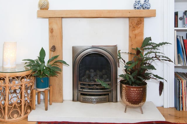 A feature fireplace with a living flame gas fire adds a homely focal point to the living room.