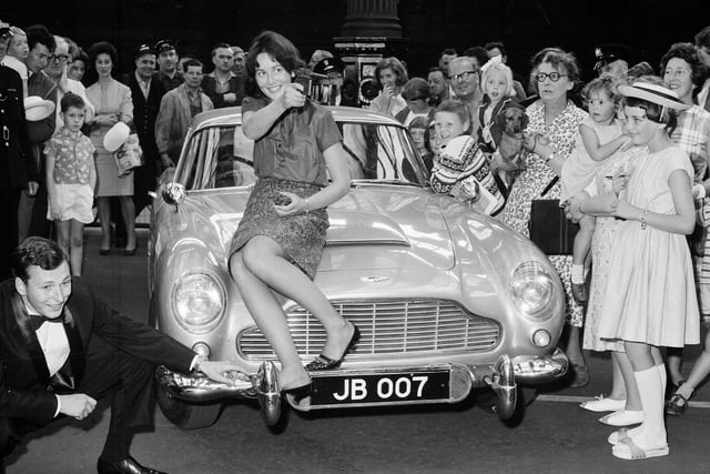 Anna Tweedie perches on James Bond's Aston Martin, which arrived in Edinburgh for a premiere of Thunderball in August 1965.
