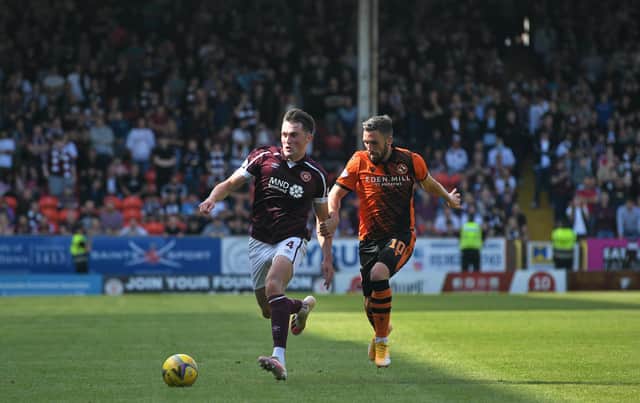 Hearts centre-back John Souttar battles for possession with Nicky Clark. Picture: SNS