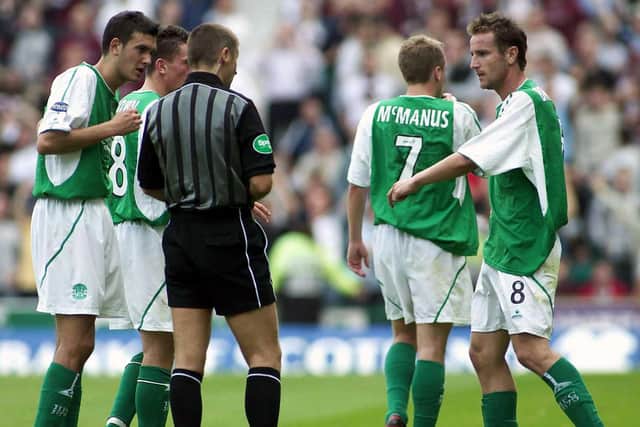 Referee Stuart Dougal sends off Grant Brebner (right) much to the dismay of his Hibs team-mates. Picture: SNS