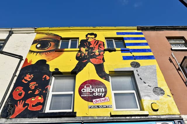 Part of the National Album Day celebrations,  a mural by local street artist Paul Curtis  who has re-imagined Elvis Costello’s debut album My Aim Is True outside the record store,  in Liverpool