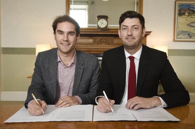 SNP group leader Adam McVey and Labour's Cammy Day sign the Edinburgh Council coalition agreement at the City Chambers (Picture: Greg Macvean)