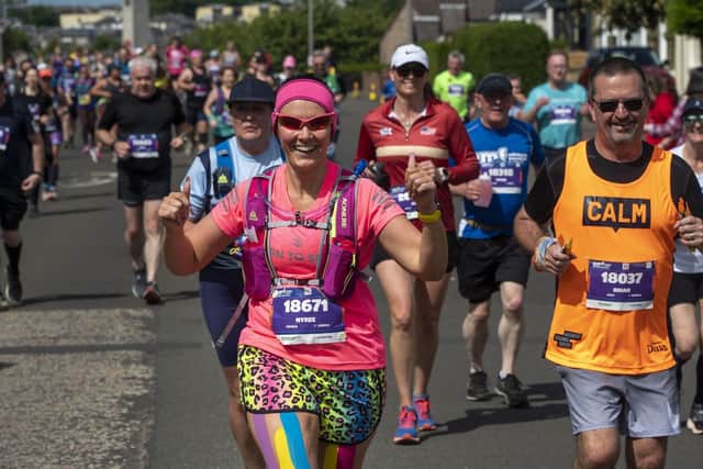 Runners in the Edinburgh marathon run through the four mile mark in the Craigentinny area on Sunday morning.