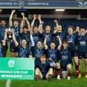 Merchiston's players celebrate with the trophy after the under-18s cup final