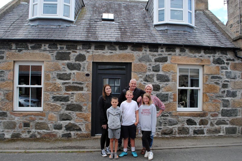 Kelly and Scott outside Old Meldrum with their children.