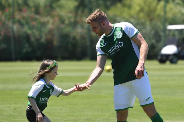 Chris Cadden meets a young Hibs fan during the club's pre-season training camp in Portugal
