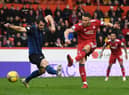 Aberdeen's Christian Ramirez shots as Hearts' Craig Halkett tries to block.