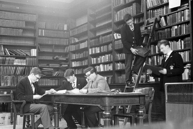 Four boys and Mr Alex Forsyth at work in the Royal High School library in January 1964.