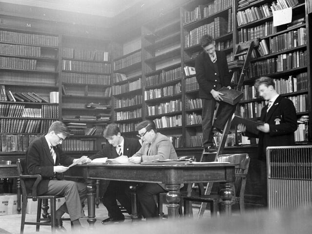 Four boys and Mr Alex Forsyth at work in the Royal High School library in January 1964.