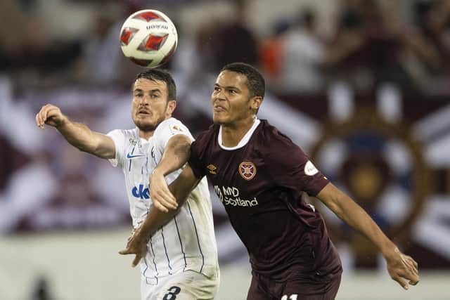 Zurich's Adrian Guerrero, left, fights for the ball with Hearts' Toby Sibbick, right, during the Europa League qualification soccer match between FC Zurich and Heart of Midlothian FC at the Kybunpark stadium in St. Gallen, Switzerland, Thursday, Aug. 18, 2022. (Ennio Leanza/Keystone via AP)