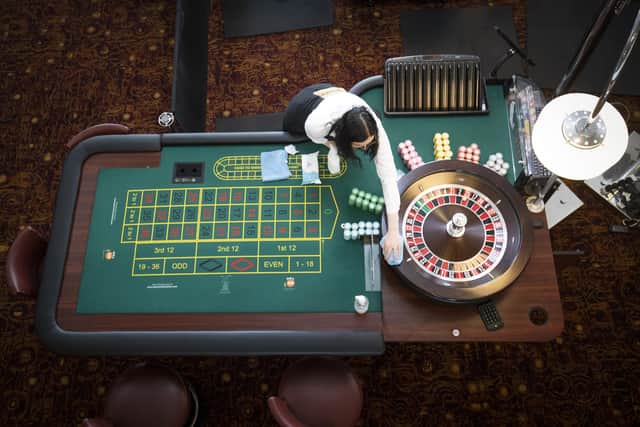 Croupier Julia Linton cleans the roulette tables at the Grosvenor Edinburgh Maybury Casino ahead of opening as most of Scotland moves to Level 2 restrictions to ease out of lockdown.