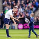 Scotland’s Stuart Hogg (right) watches as his son Archie delivers the match ball to referee Luke Pearce ahead of the Guinness Six Nations match at BT Murrayfield Stadium, Edinburgh.