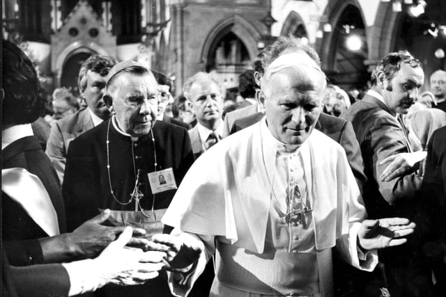 His Holiness Pope John Paul II walks through the congregation in St Mary's RC Cathedral, in Broughton Place, with Cardinal Gordon Joseph Gray in the background.