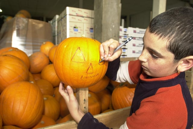Nine-year-old Royston Primary School pupil Connor Markey marks out a face on a pumpkin ahead of Halloween in 2012.