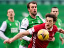 Christian Doidge of Hibs battles for the ball with Aberdeen's Ash Taylor