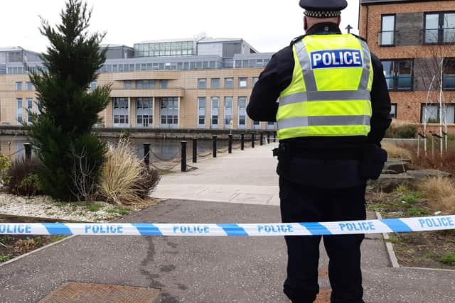 A police cordon remains in place at Leith Docks after a man fell in the water