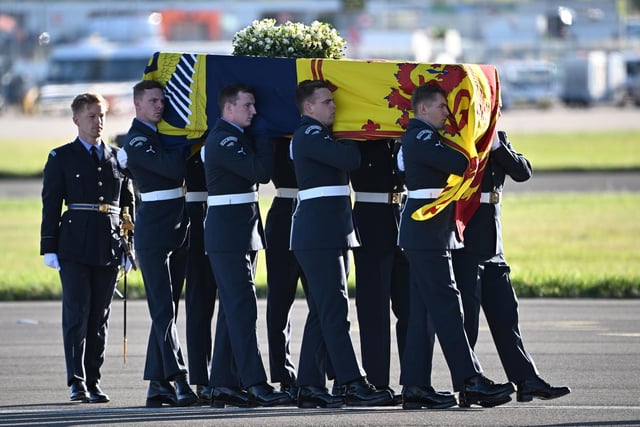 A bearer party from Queen's Colour Squadron of the Royal Air Force (RAF) carry the coffin of Queen Elizabeth II aboard an RAF aircraft on its journey from Edinburgh to Buckingham Palace, London, where it will lie at rest.