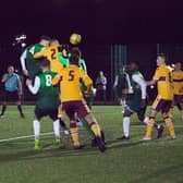 Murray Aiken (number 4) heads home a last-minute equaliser for Hibs against Motherwell. Picture: Maurice Dougan