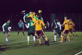 Murray Aiken (number 4) heads home a last-minute equaliser for Hibs against Motherwell. Picture: Maurice Dougan