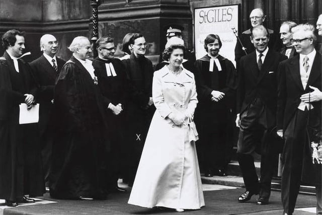 The Queen attended the opening of the General Assembly of the Church of Scotland in May 1977 during her Silver Jubilee visit.
Here the Queen and the Duke of Edinburgh are pictured with ministers and other dignitaries as they leave St Giles Cathedral after the pre-Assembly service.
She is wearing a long pale dress coat. Prince Philip stands to one side smiling. A policeman can be seen in the background.
