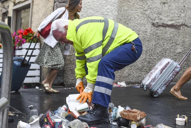 A worker helps to clean up the city centre after almost two weeks of strike action. Photo: Lisa Ferguson.