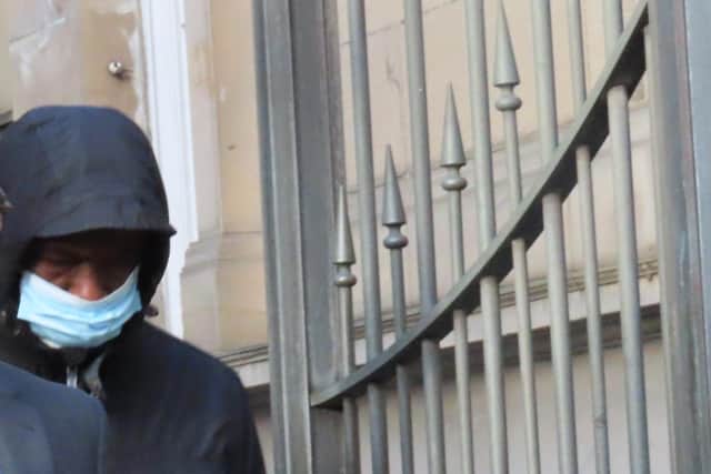 Disgraced priest Father Martins Enegbuma tried to hide his face at Edinburgh Sheriff Court.
