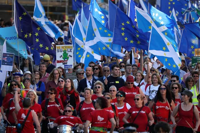 Scottish Saltires and Flags of Europe fly during the March to Remain in the EU in Edinburgh in 2019 (Picture: Andrew Milligan/PA Wire)